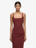 Woman wearing a burgundy dress on a white background