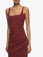 Maroon dress worn by a model on a white background