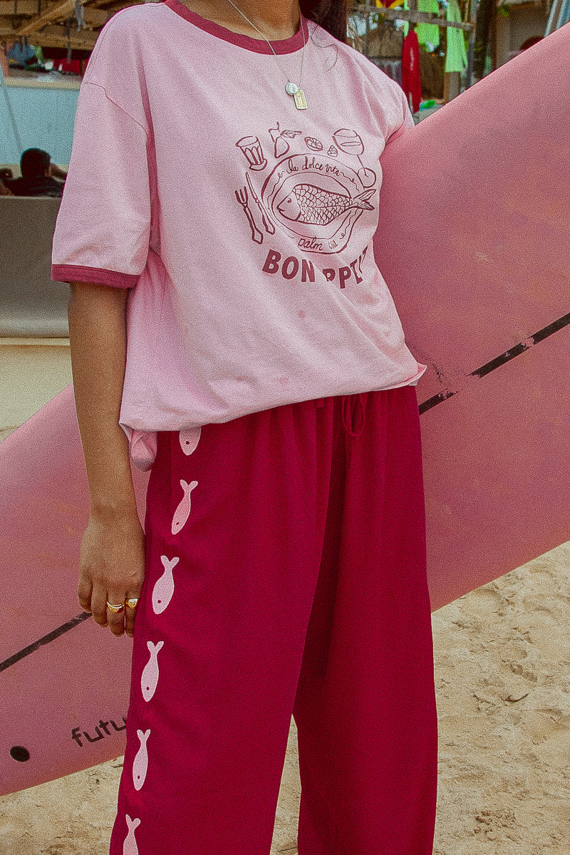 Deep red pants from Palm Collective with embroidered fish down the sides. 