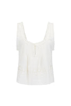 White sleeveless top with lace details on a white background