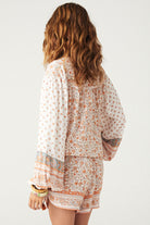 Sunshine Bandit Blouse in Desert Sage paired with blue wash jeans