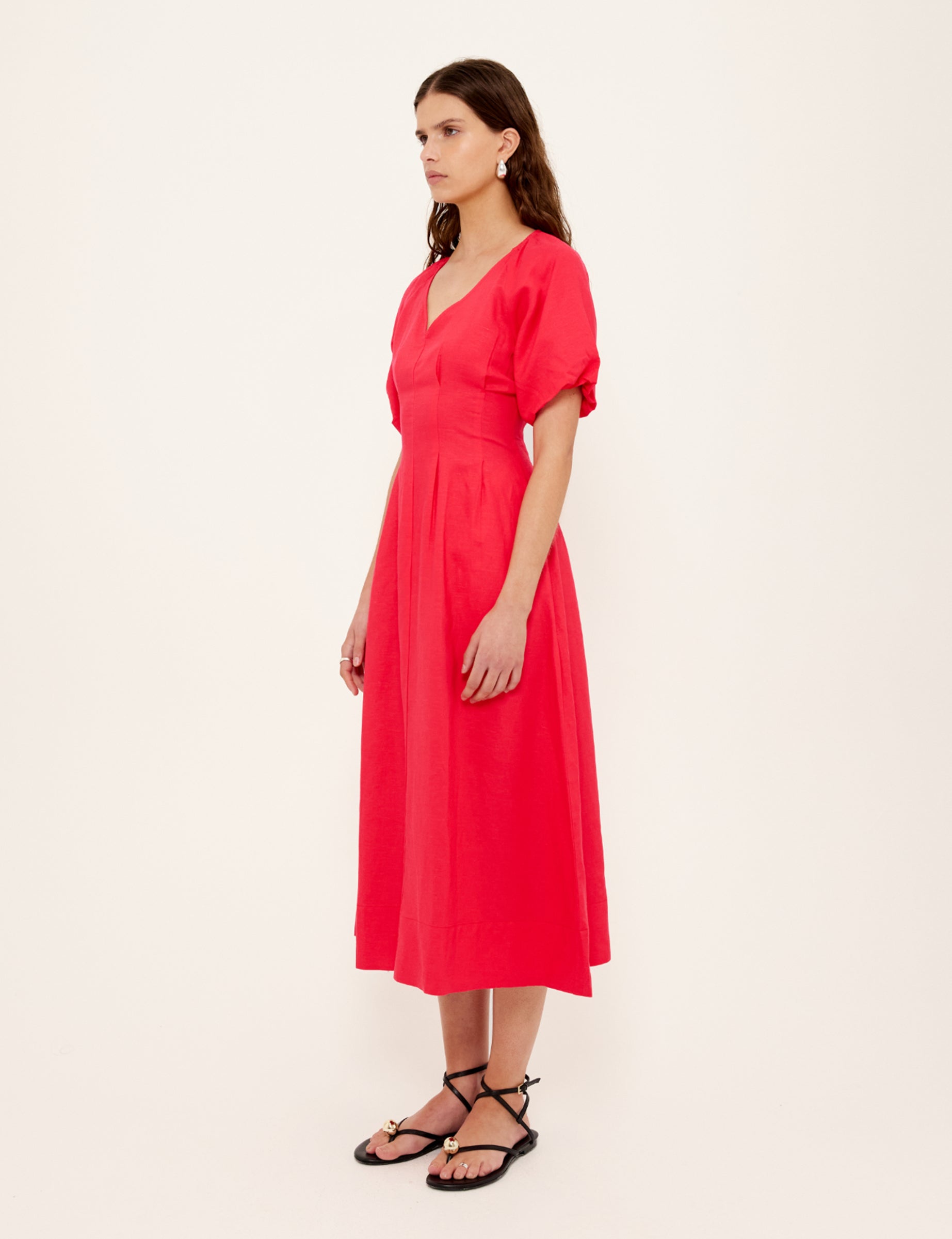 Woman wearing a red dress against a white background