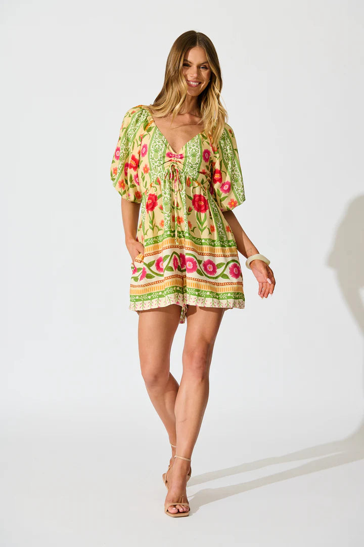 Woman wearing a colorful floral dress on a white background