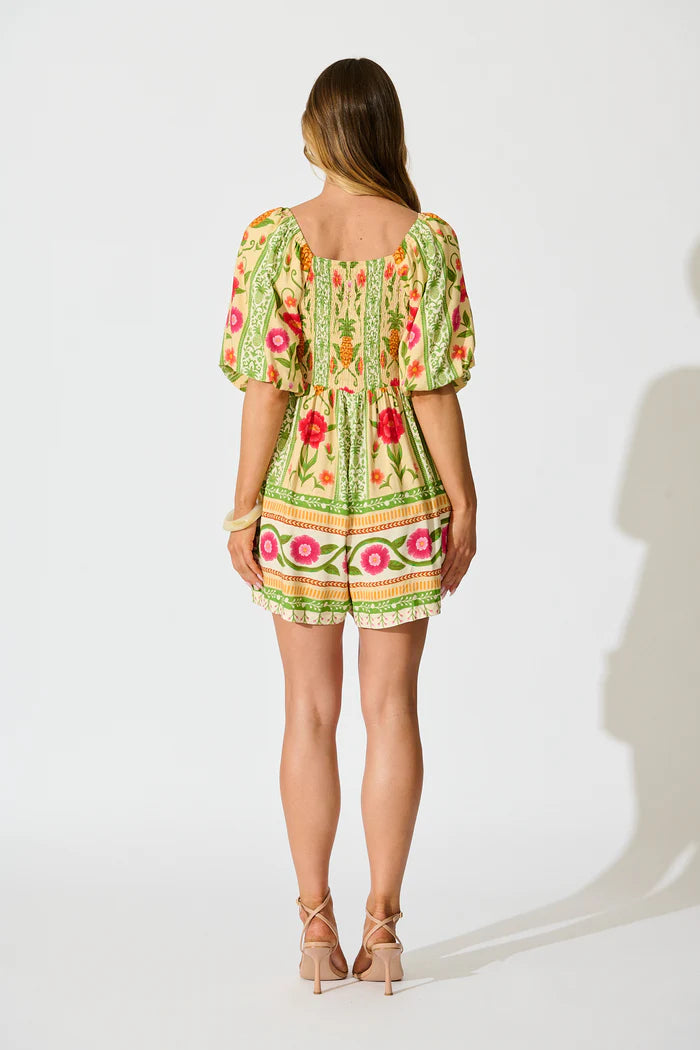 Woman wearing a colorful floral dress on a white background