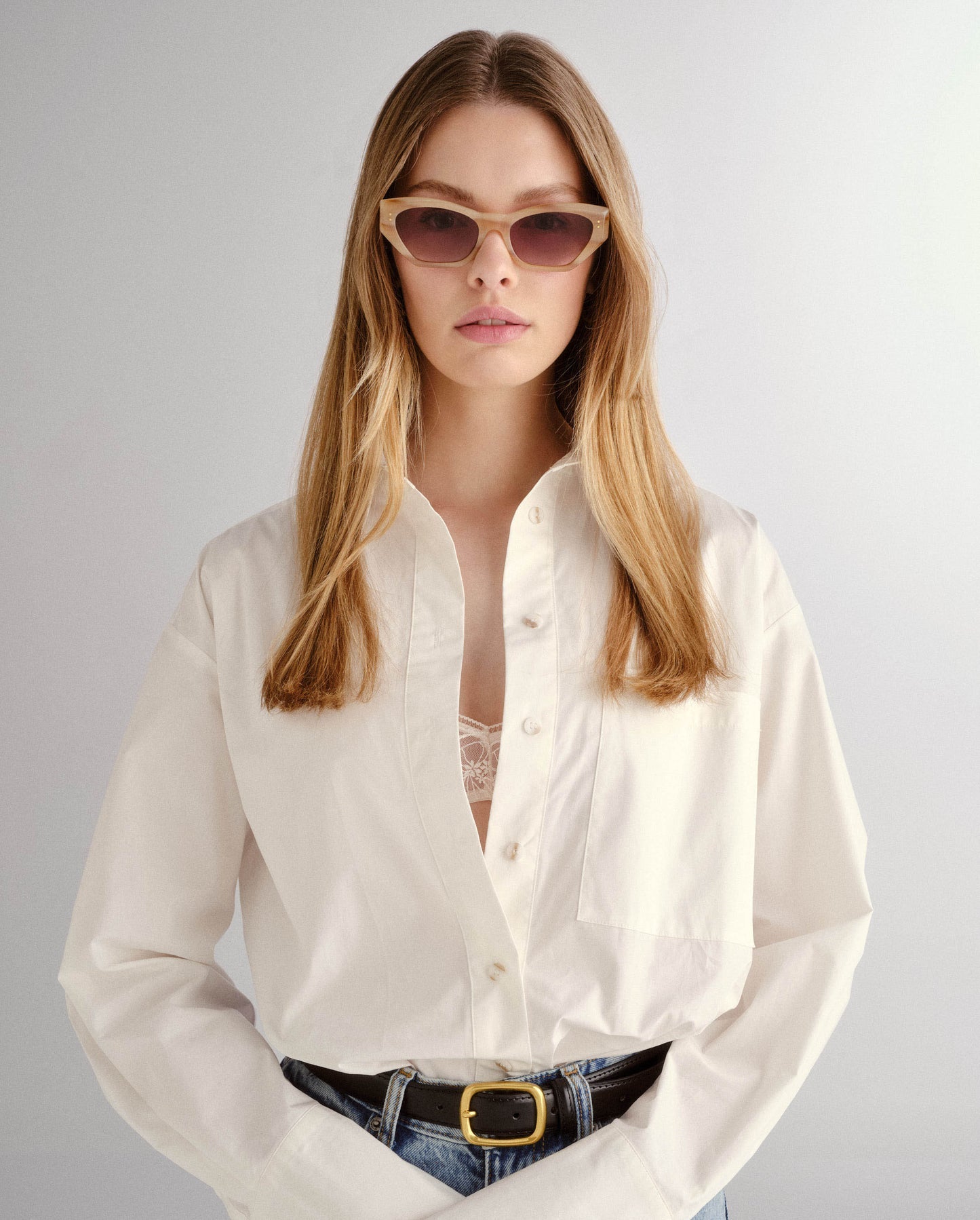 The Sydney Oat Sunglasses from Luv Lou worn by a blonde woman with white shirt