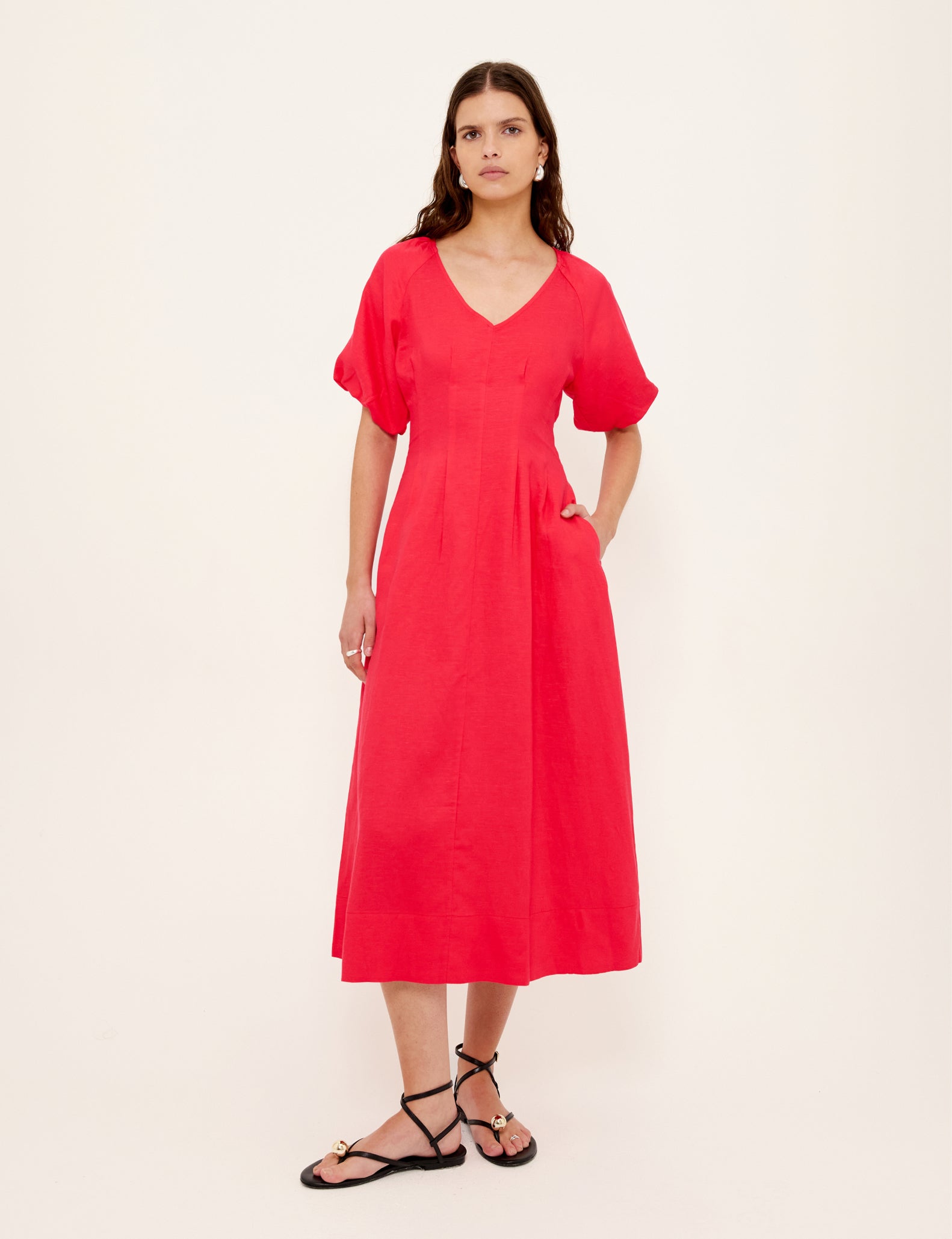 Woman wearing a red dress on a white background