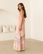 Ebby and I Luciana Maxi Dress worn by model on a white background. Coral placement print maxi with adjustable straps.