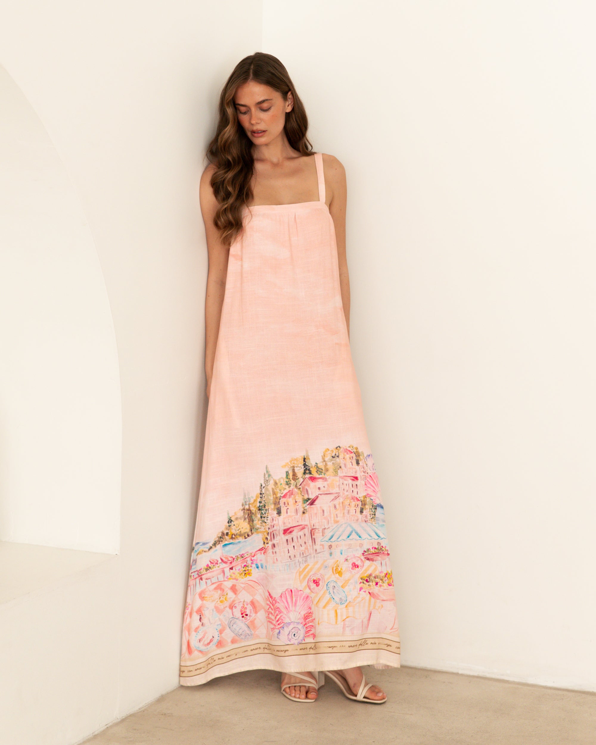 Ebby and I Luciana Maxi Dress worn by model on a white background. Coral placement print maxi with adjustable straps.