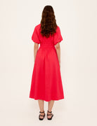 Person wearing a red dress on a white background