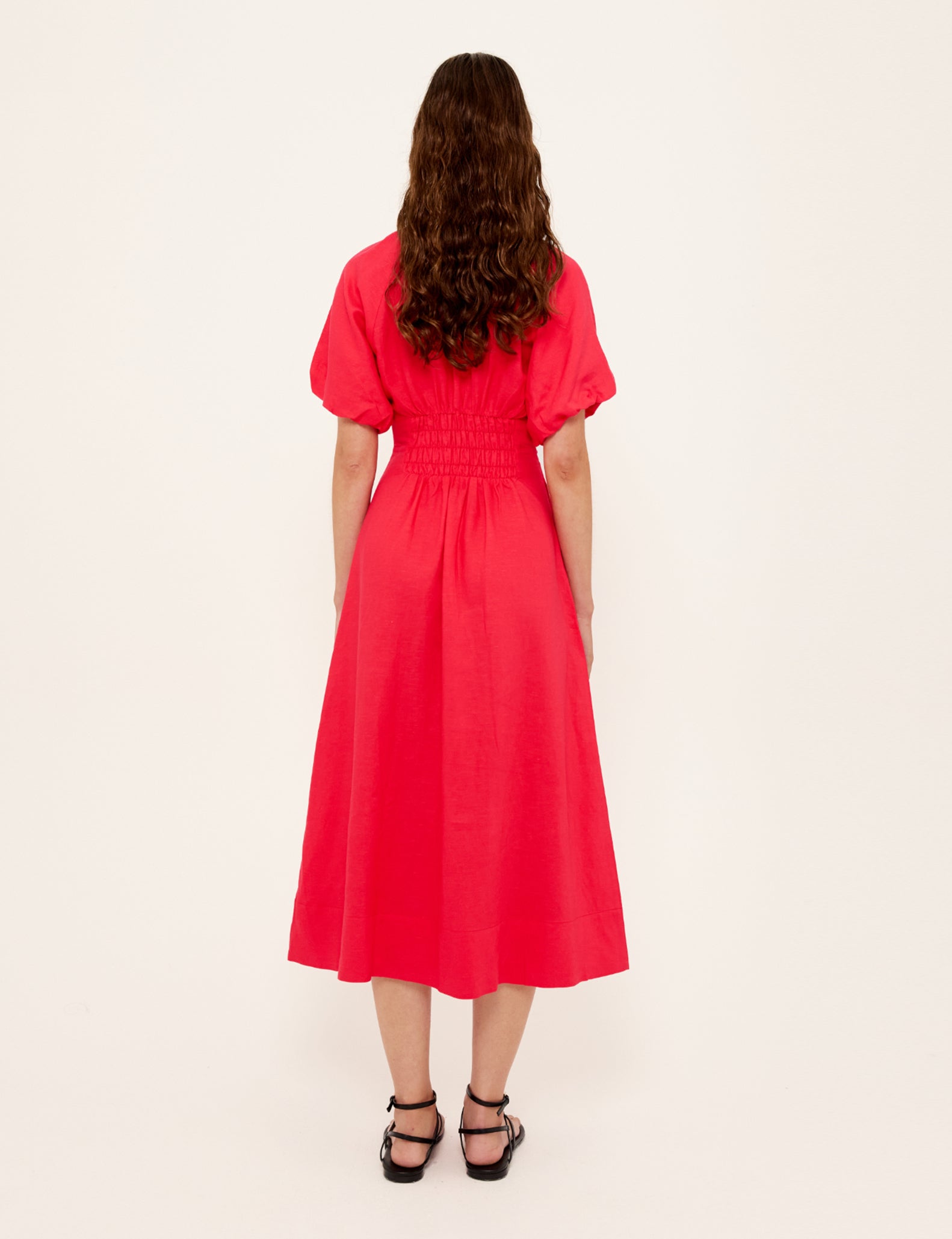 Person wearing a red dress on a white background