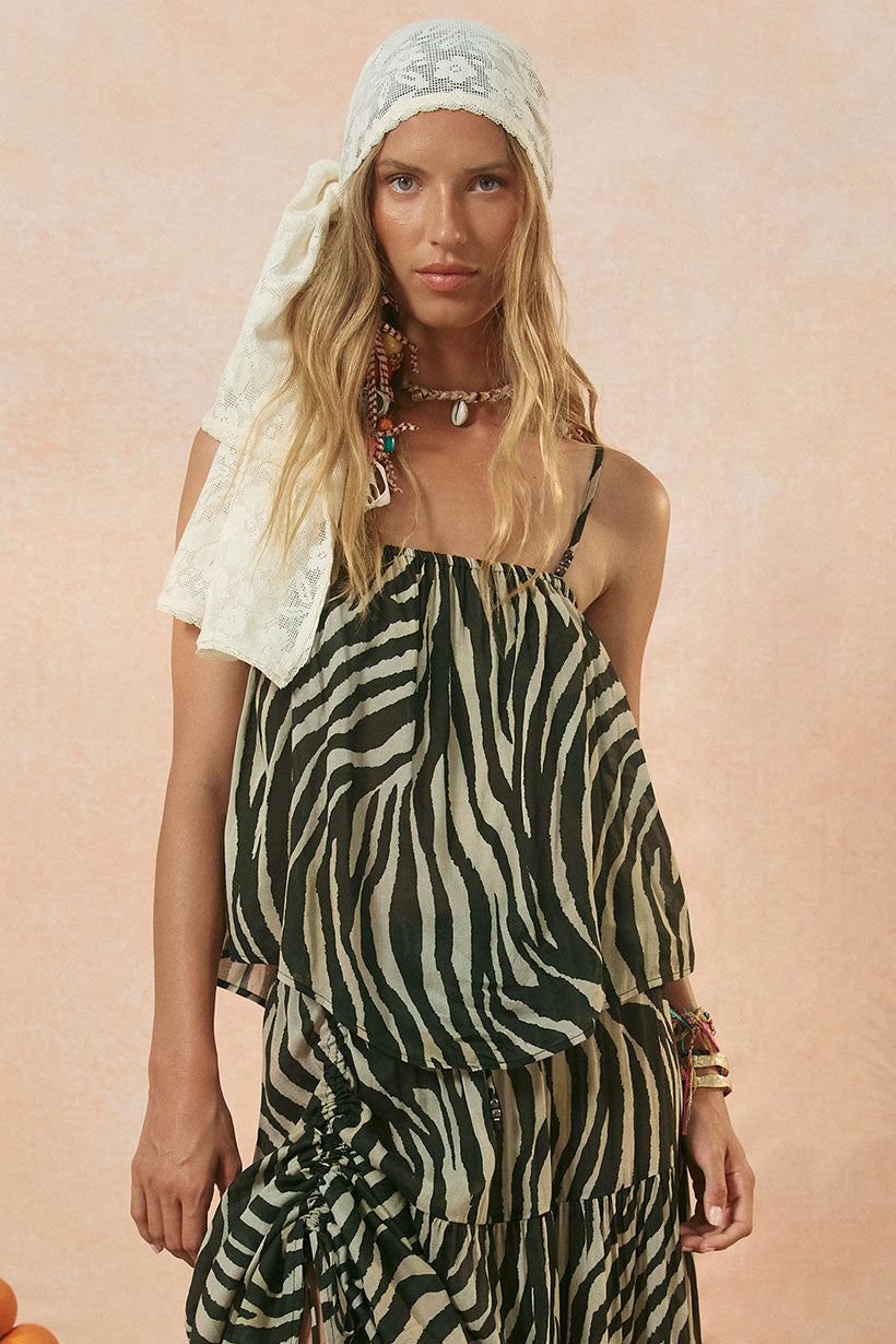 A model is wearing a sleeveless camisole top with a zebra print design in washed charcoal color.