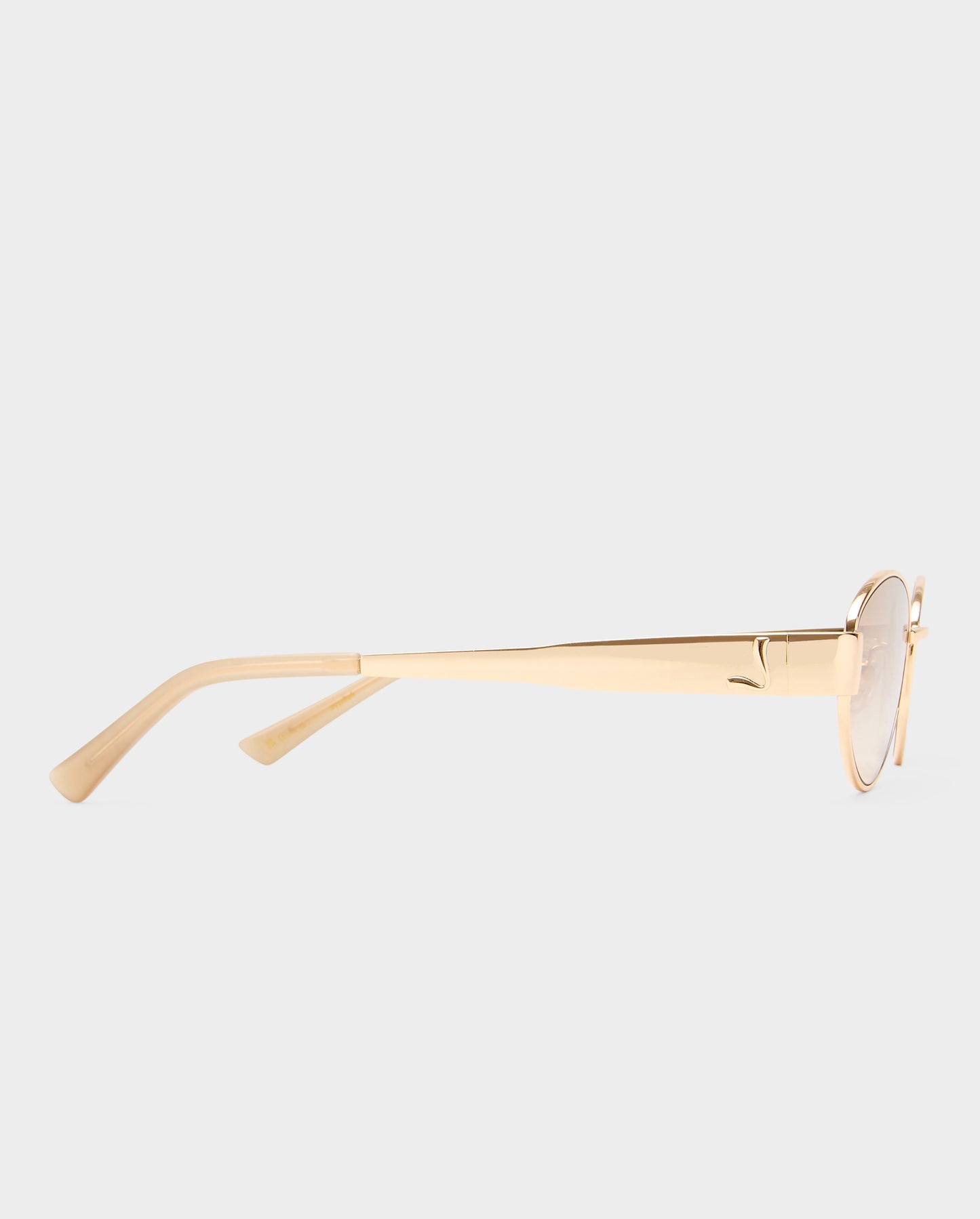 Gold-framed sunglasses on a light gray background