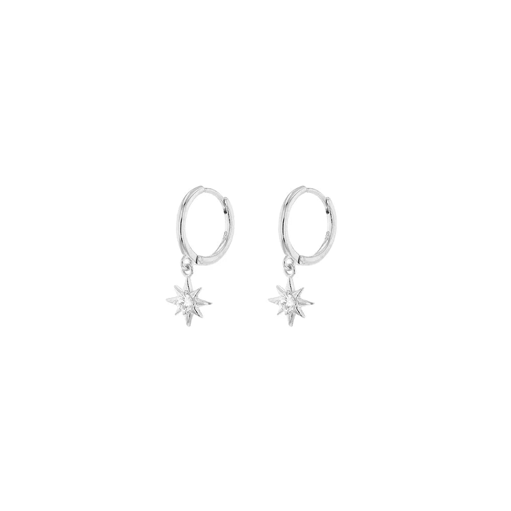 Pair of silver hoop earrings with star-shaped drops on a white background