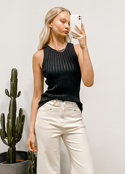 Model wearing the black thea tank from paper heart in viscose nylon ribbed knit fabric