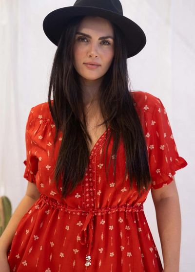 Model wearing a red boho maxi dress with border print at the bottom