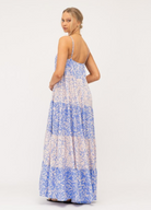 Model wearing tiered Livia Maxi Dress in blue and white mixed media print