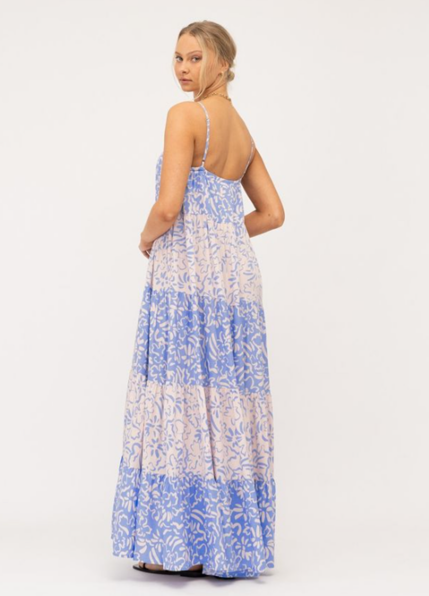 Model wearing tiered Livia Maxi Dress in blue and white mixed media print