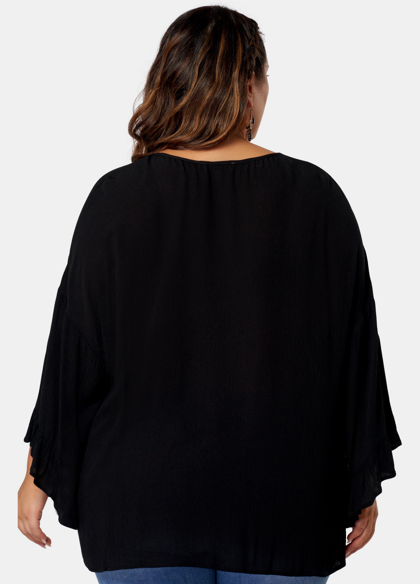 Woman wearing black boho blouse from the back