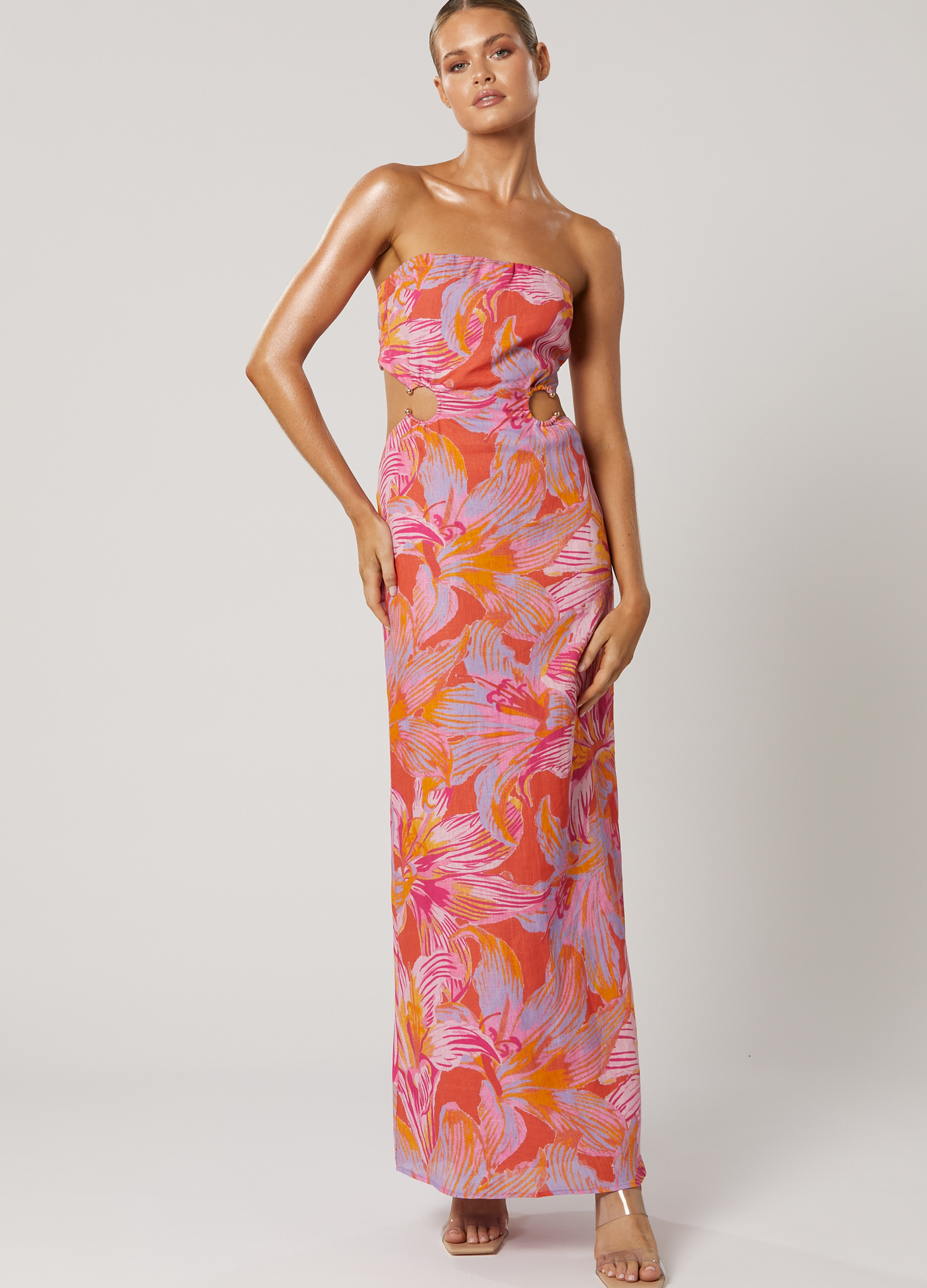 Model wearing the Avalyn Printed Maxi Dress with cut outs and strapless neckline