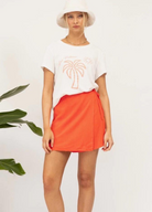 White tee with orange palm tree motif