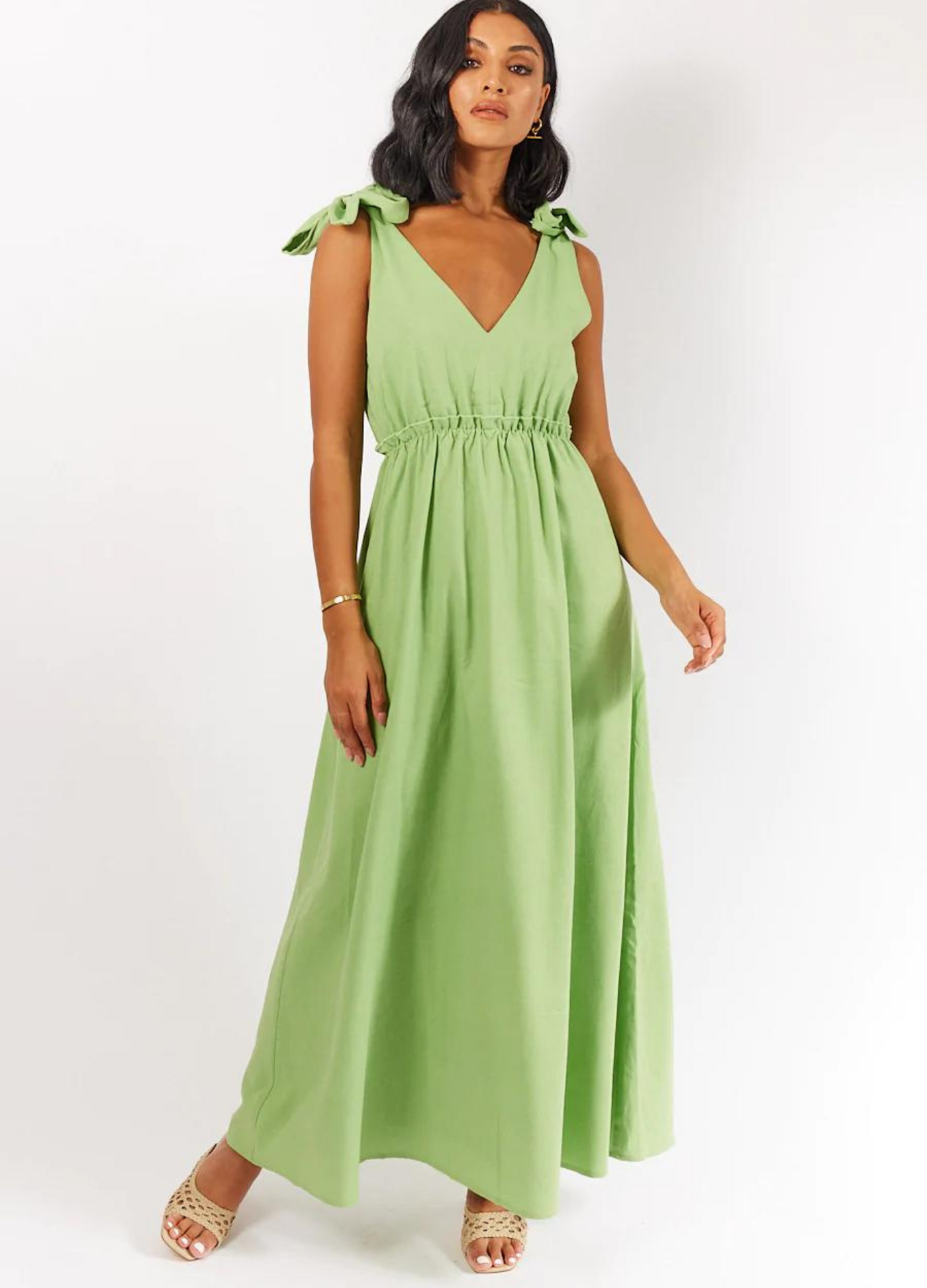 Model wearing Promise Apple Green Dress with tie shoulders and elasticated waist detail