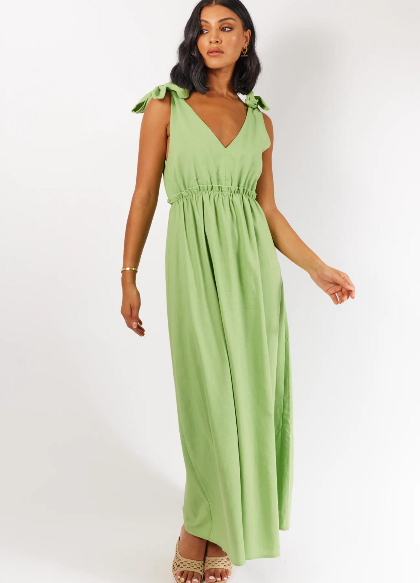 Model wearing Promise Apple Green Dress with tie shoulders and elasticated waist detail