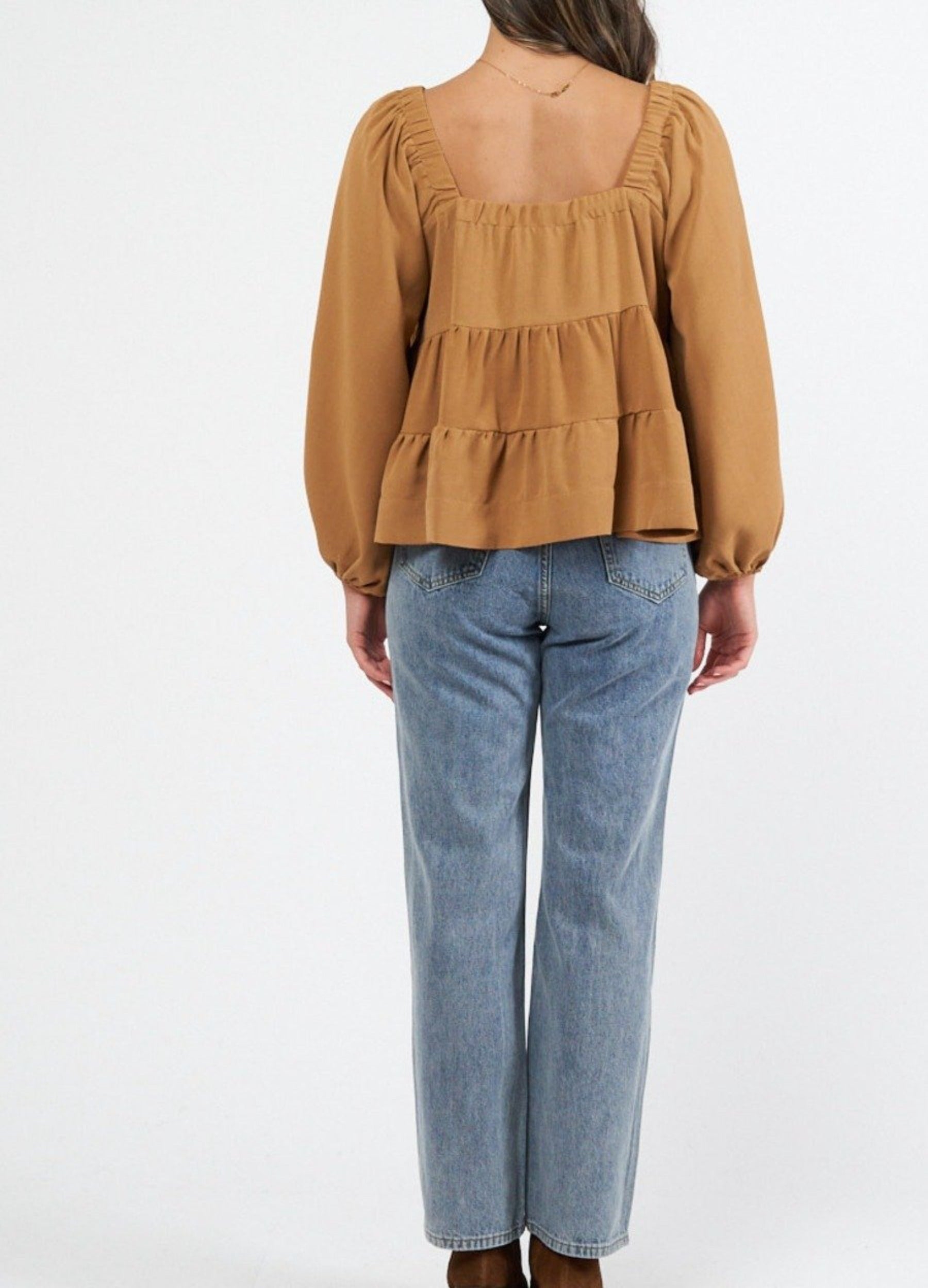 Woman wearing cinnamon colour trapeze top