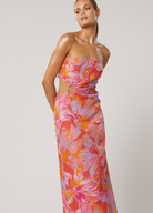 Model wearing the Avalyn Printed Maxi Dress with cut outs and strapless neckline