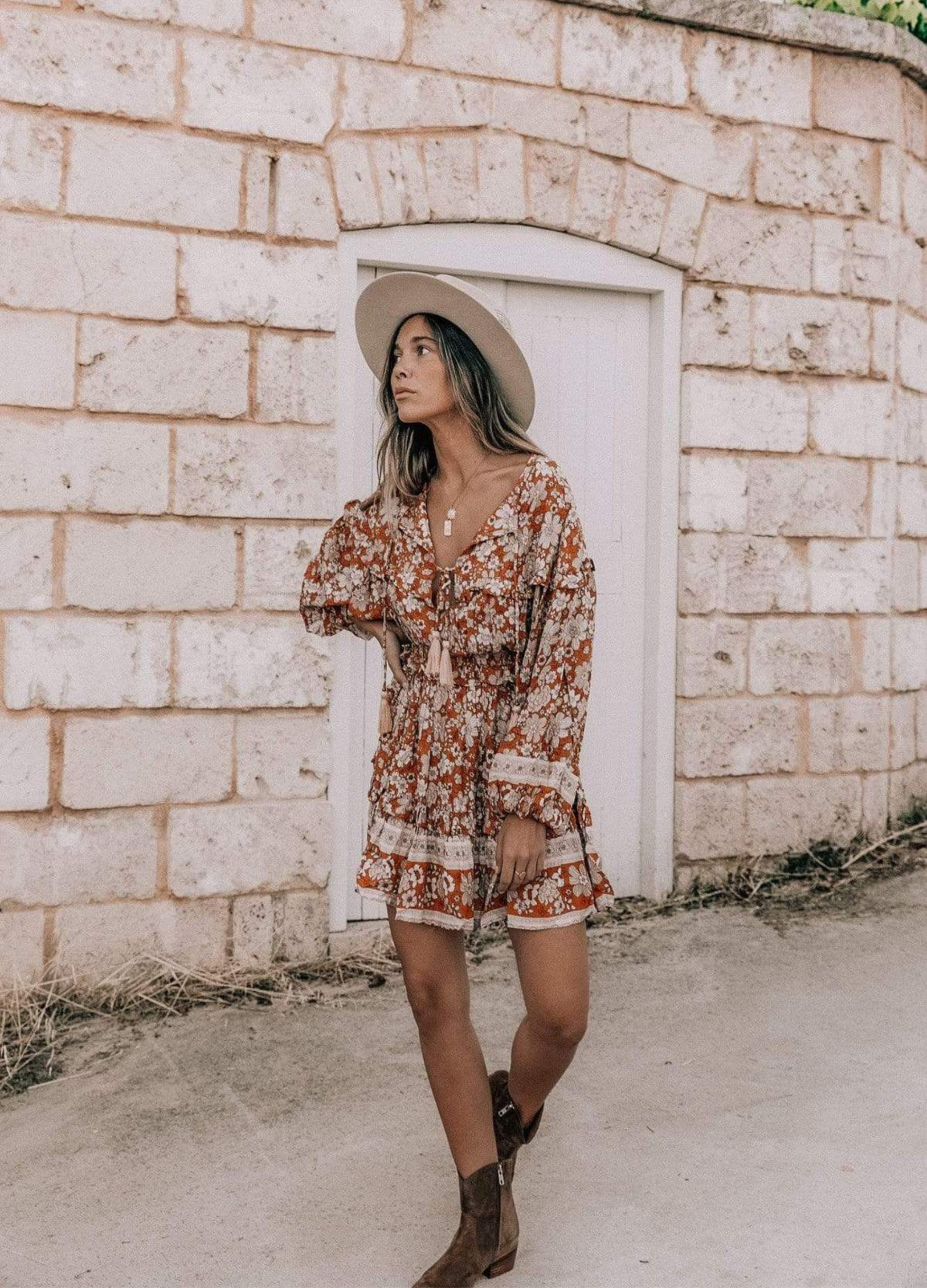 Model wearing floral print boho mini dress