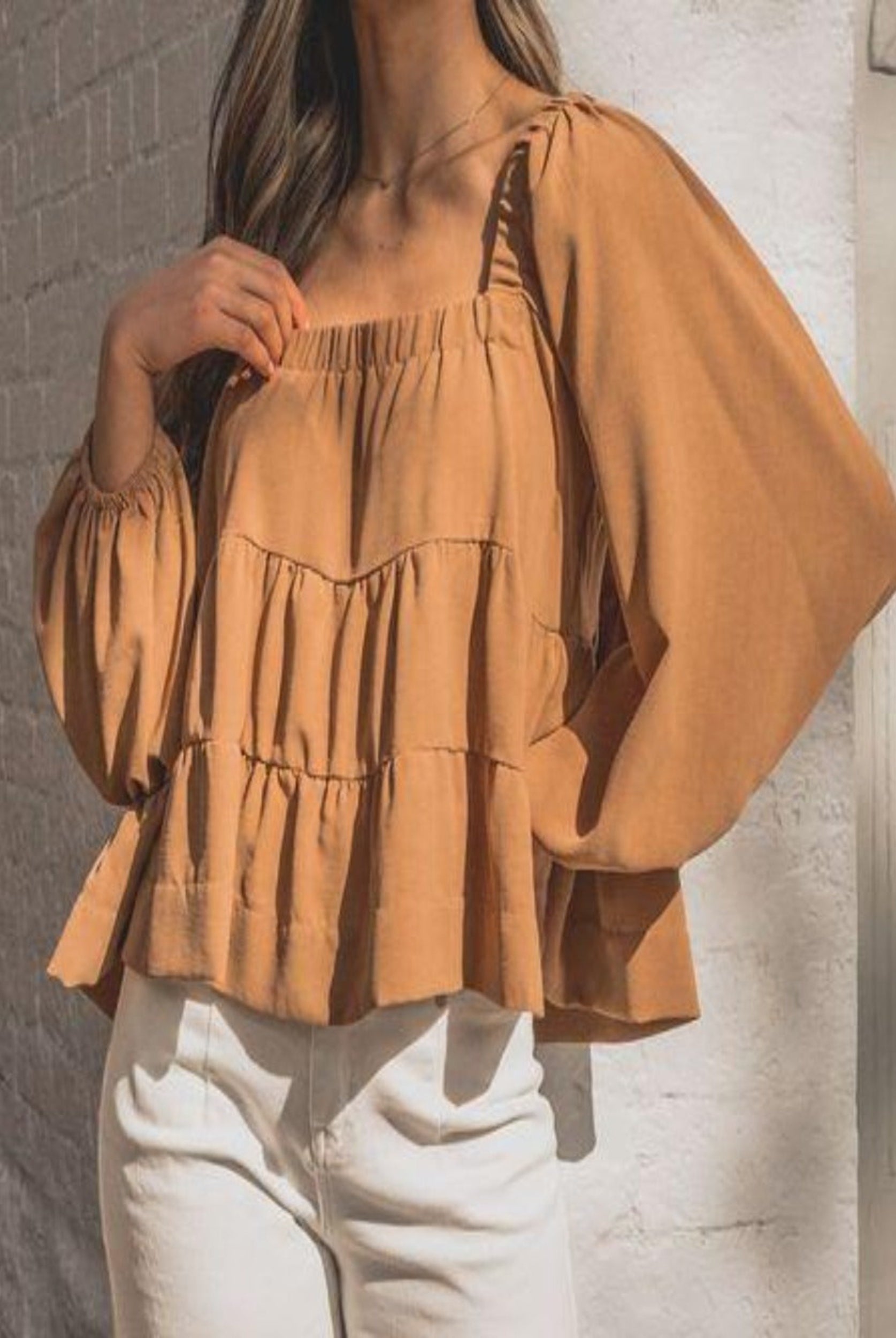 Woman wearing cinnamon colour trapeze top
