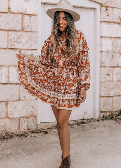 Model wearing floral print boho mini dress