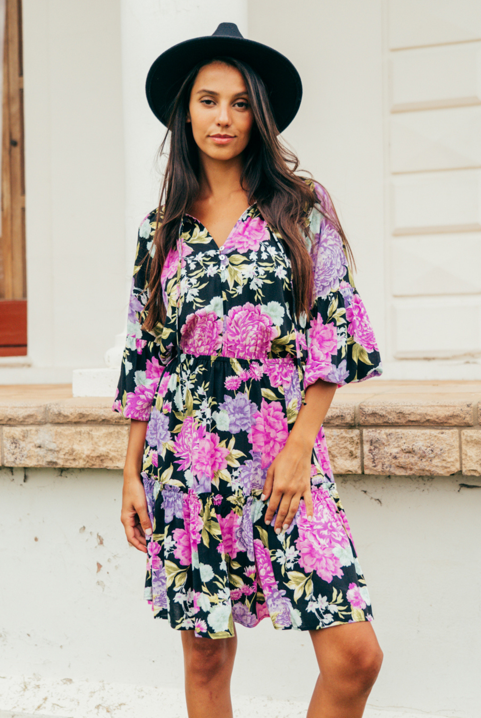 Model wearing the tarni mini dress in floral print