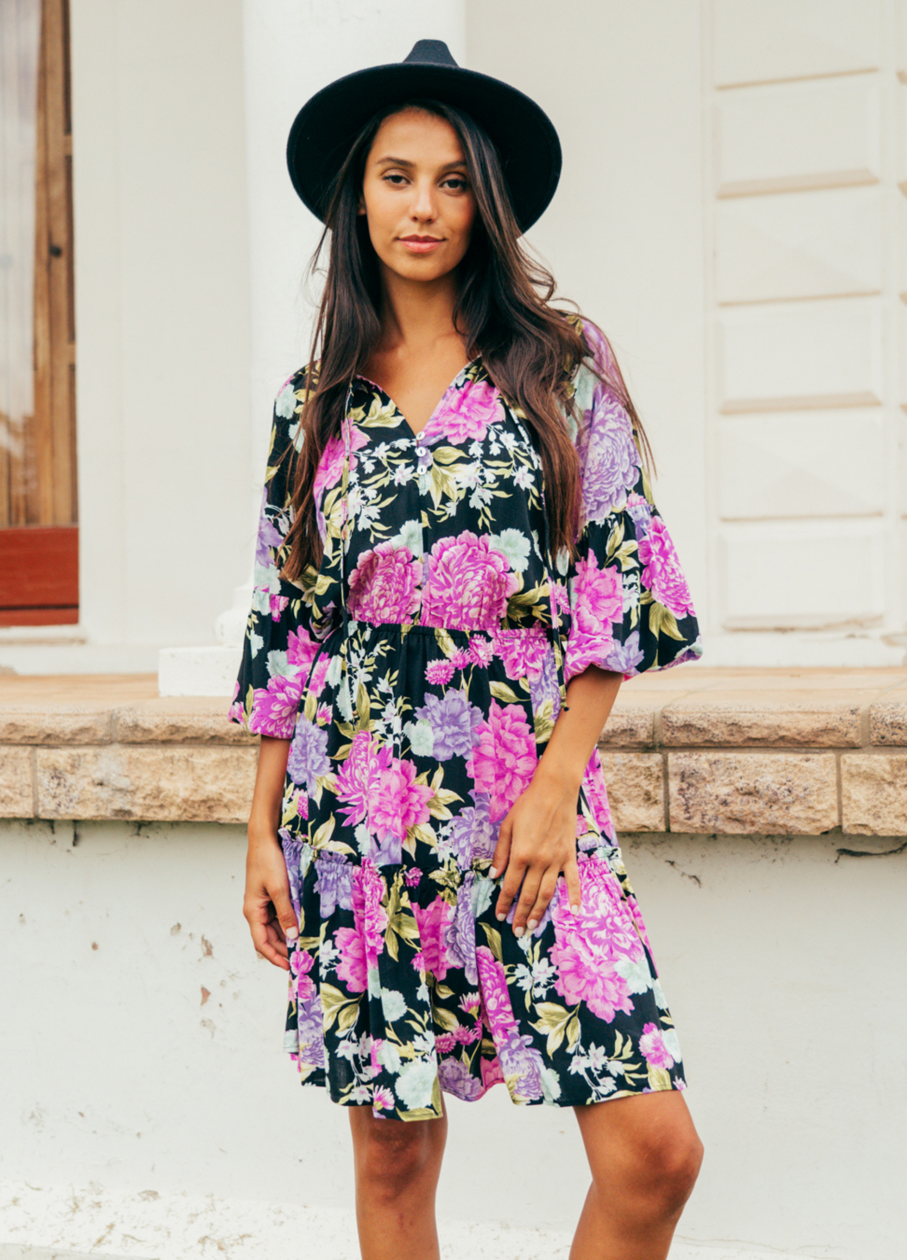 Model wearing the tarni mini dress in floral print