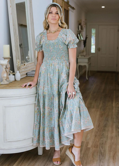 Model wearing the house of skye Daisy Belle dress in floral print with shirred bust and puff sleeve