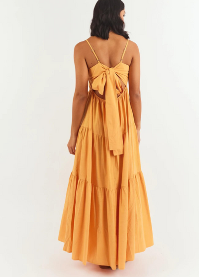 Model wearing orange strappy tiered astrid maxi dress from girl and the sun