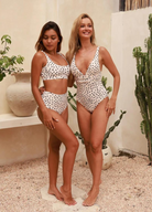 Model wearing the popcorn tan gia and ginger from infamous swim