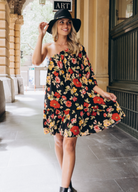 Model wearing the Josephina one shoulder dress in black base floral print