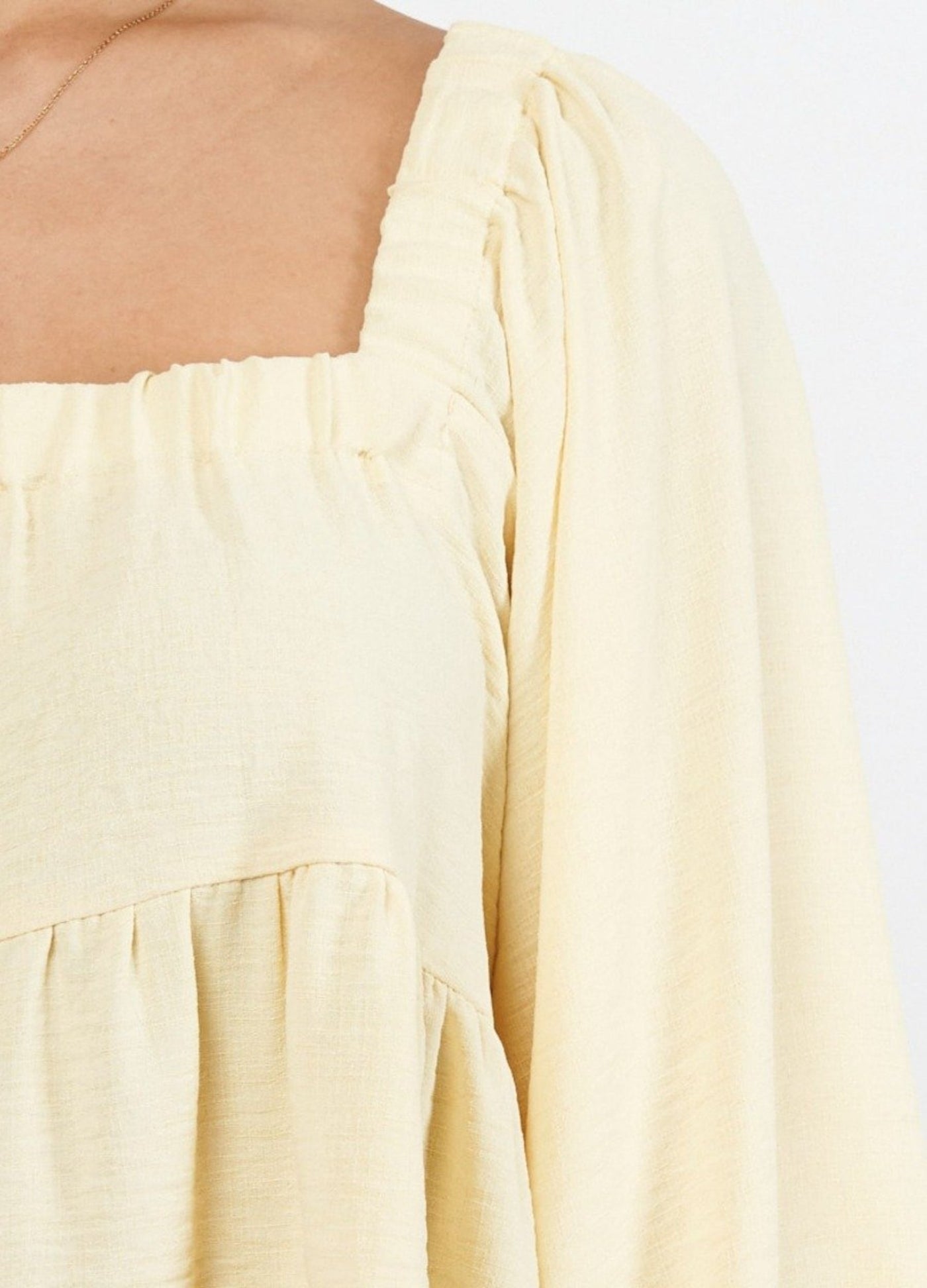Close up of yellow top