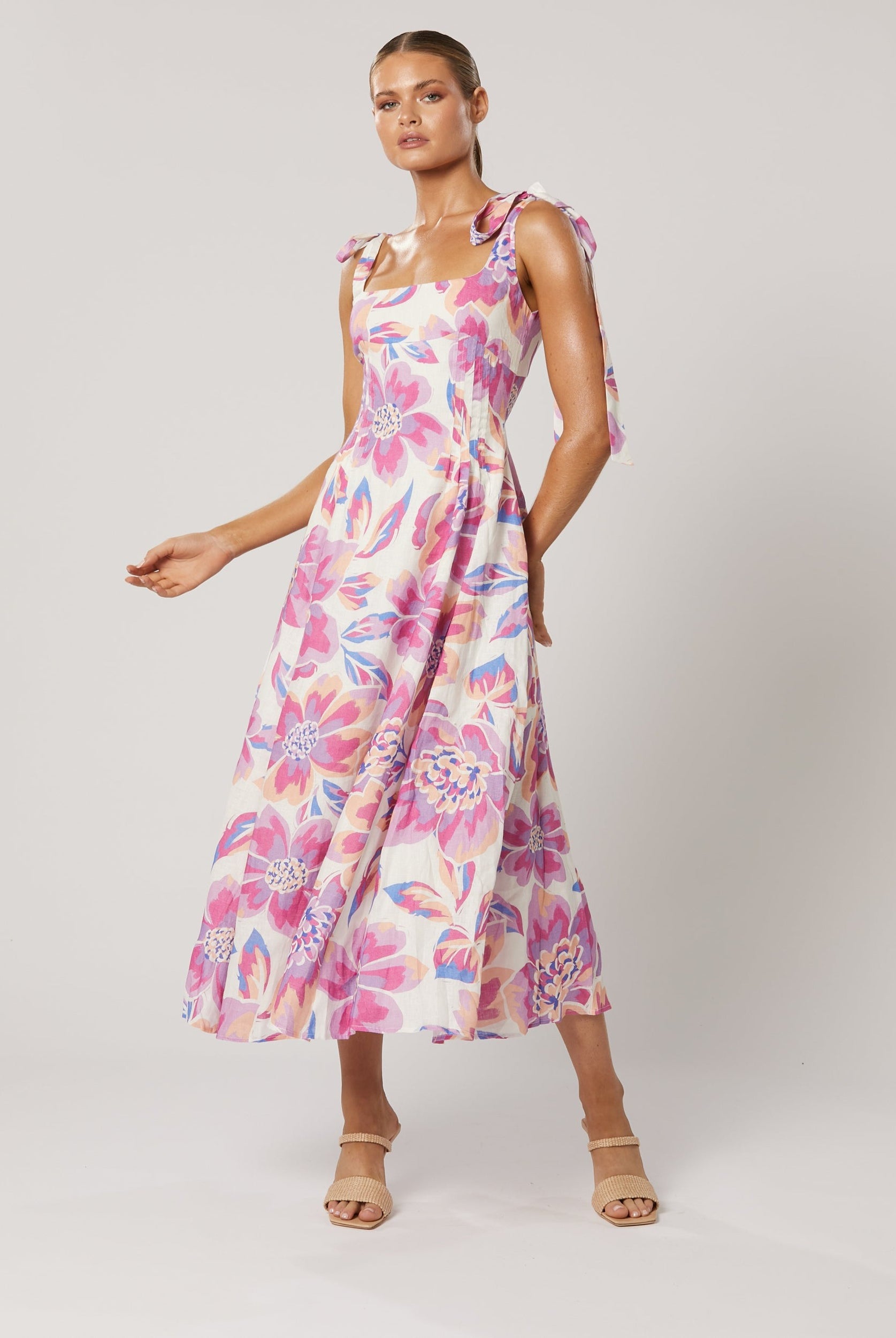 Model wearing the Audra Midi Dress - pink floral print midi with tie straps