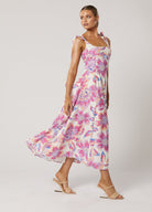 Model wearing the Audra Print Midi Dress in pretty pink floral print with tie shoulder straps