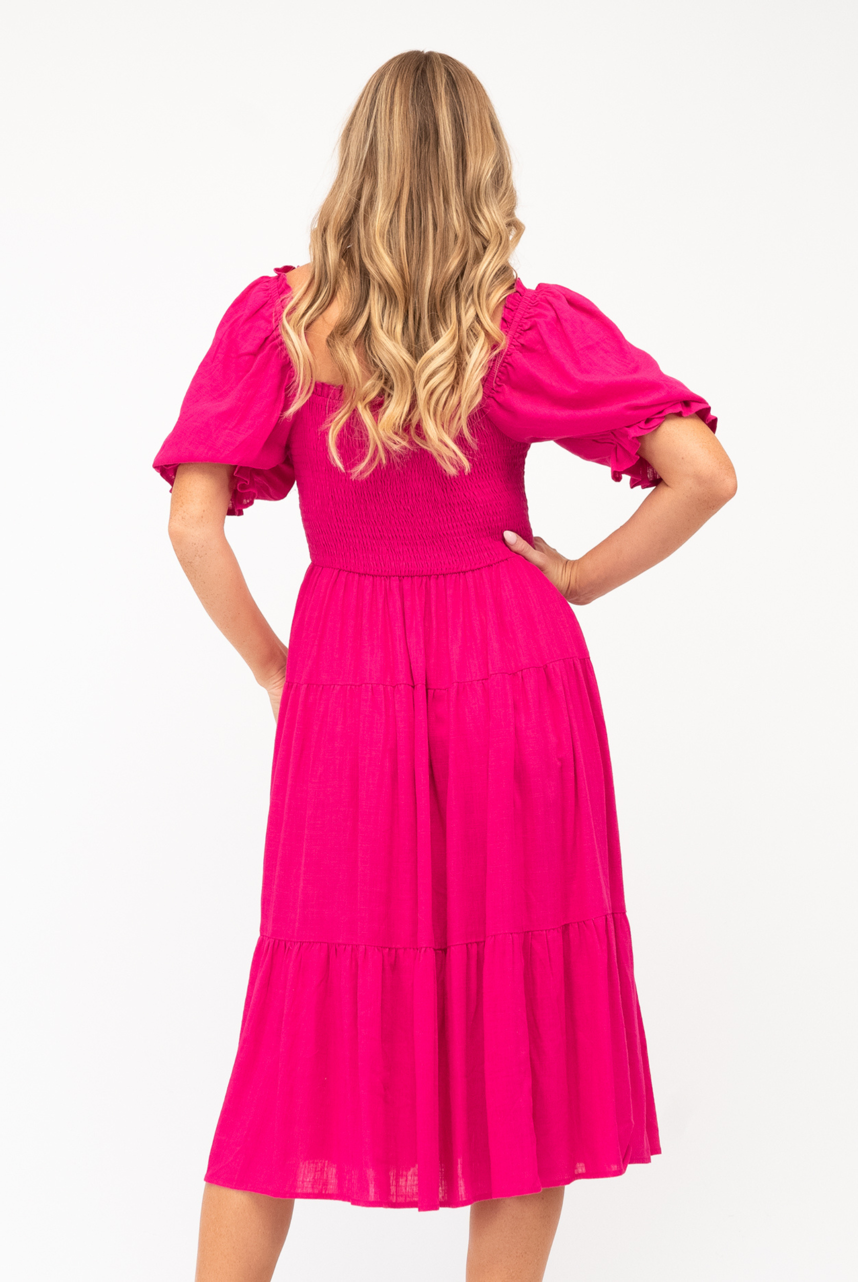 Model wearing the pink Bobbie Dress from Label of Love
