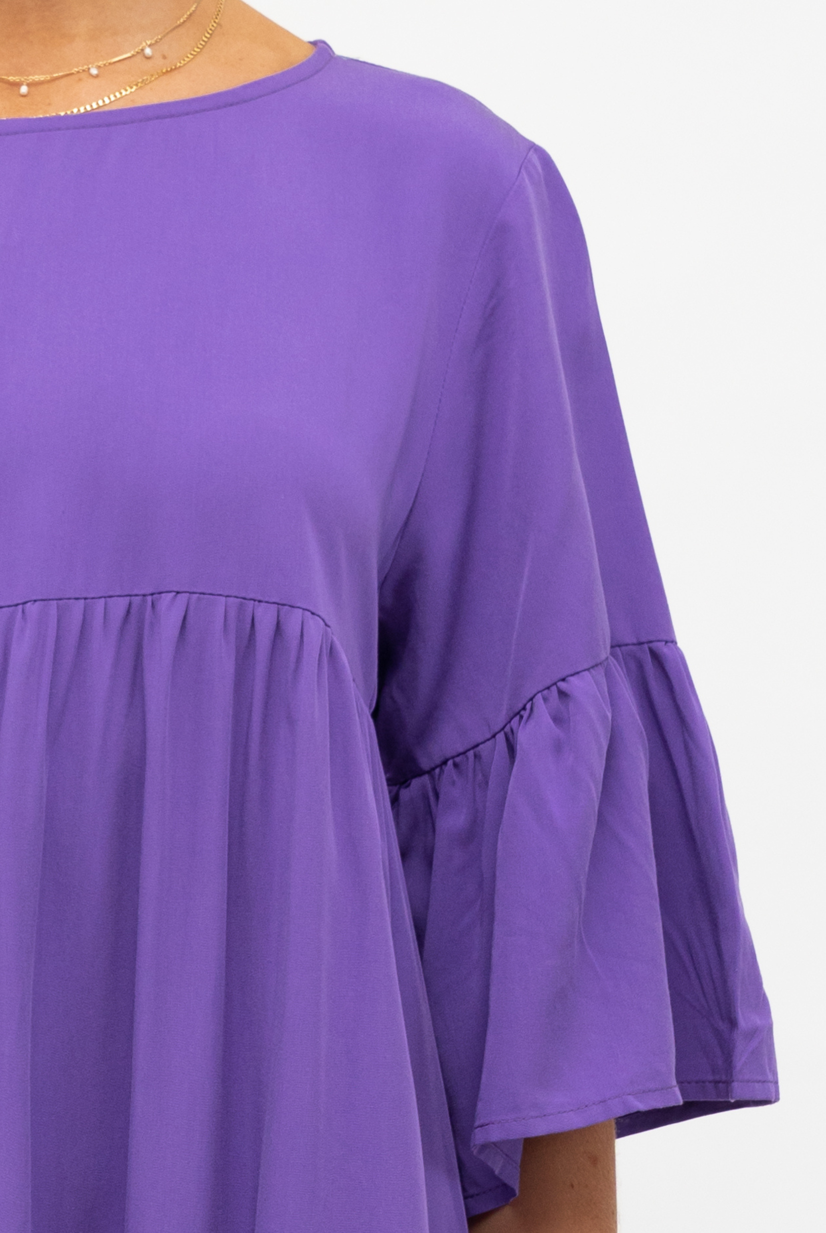 Model wearing purple tiered dress with a flattering mid length sleeve from label of love