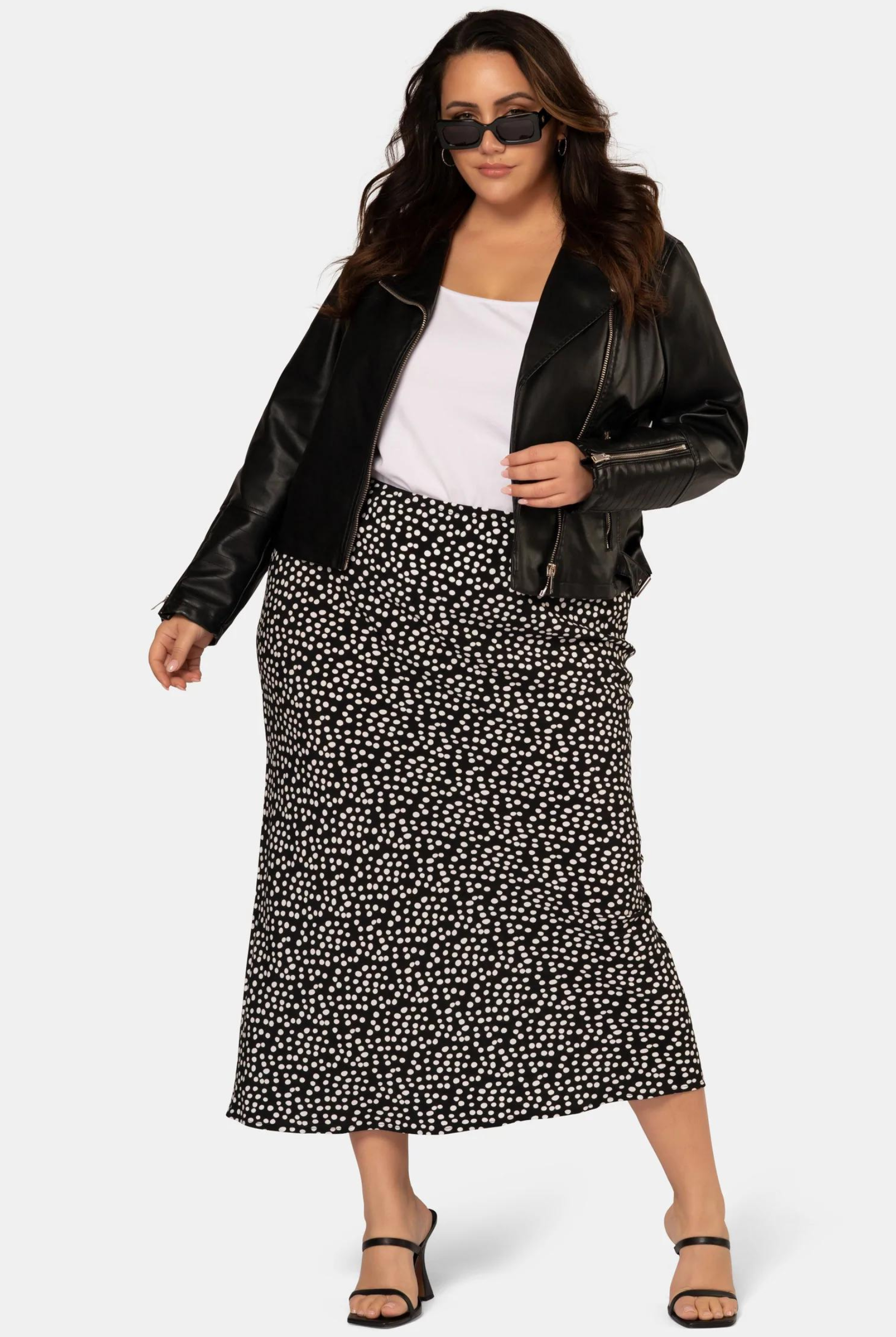 Model wearing the black and white spot print midi skirt in viscose crepe