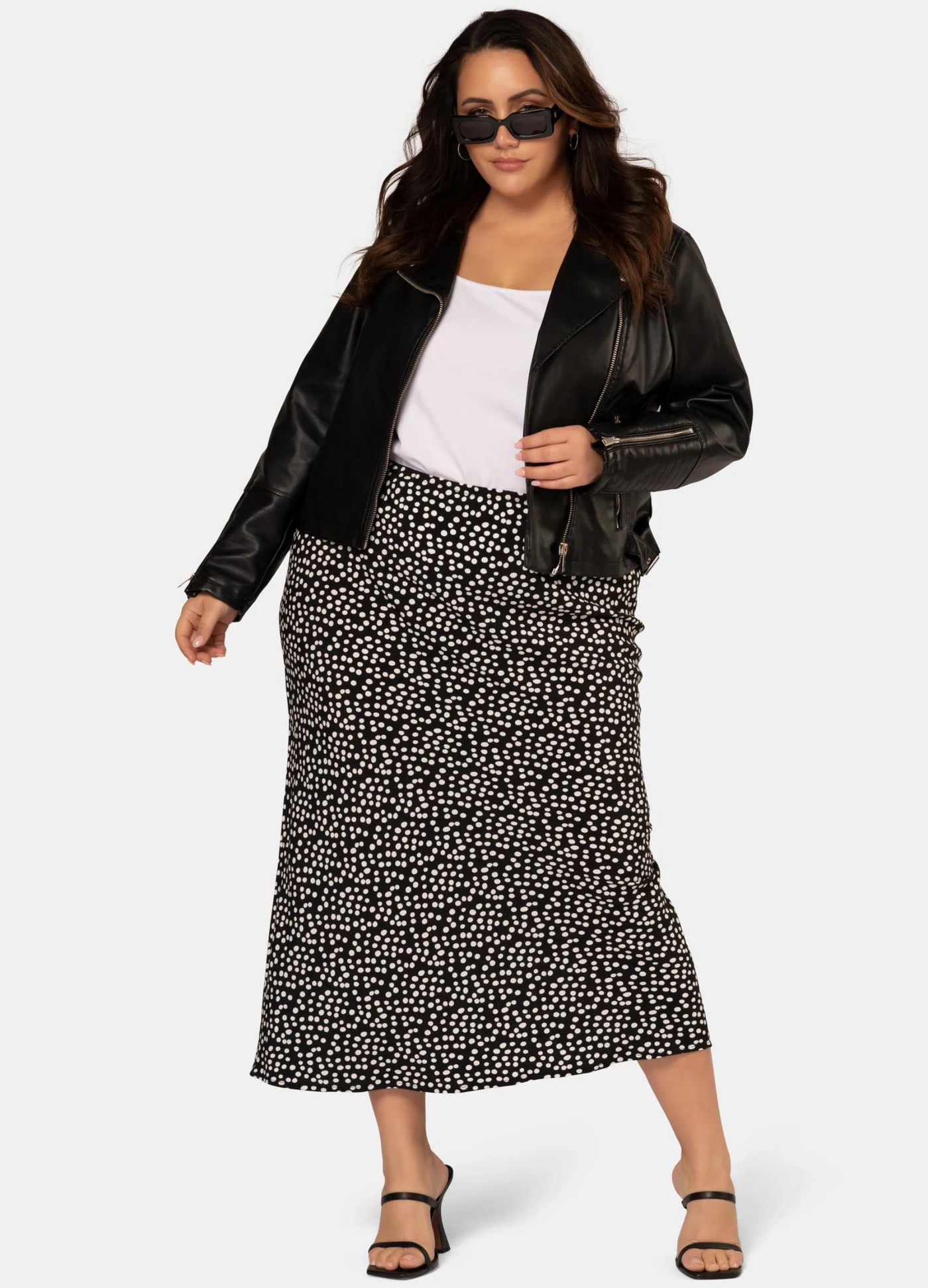 Model wearing the black and white spot print midi skirt in viscose crepe