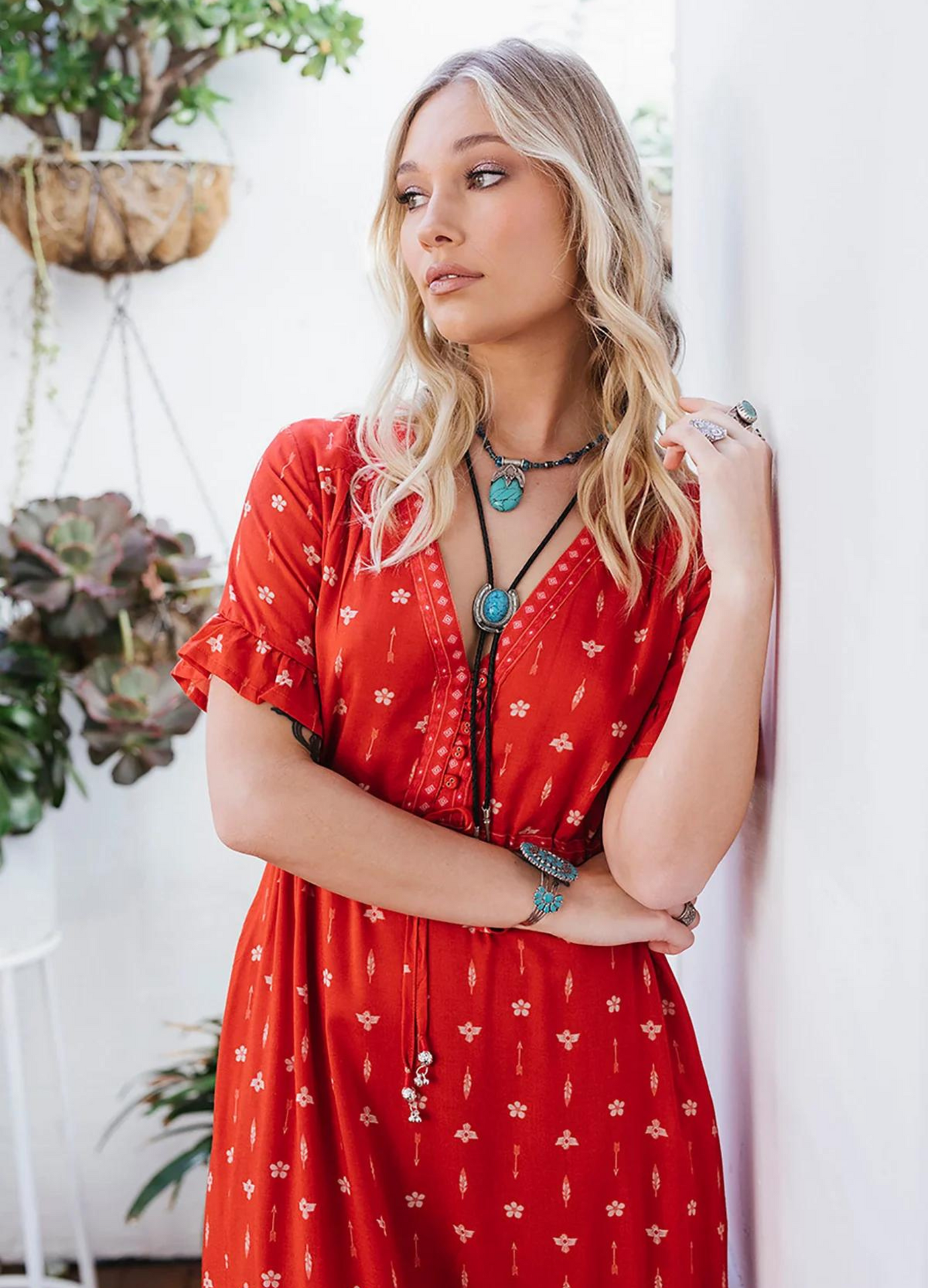 Model wearing a red boho maxi dress with border print at the bottom