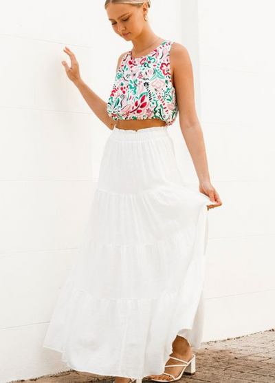 Model wearing a tiered off white maxi skirt with elasticated waistband