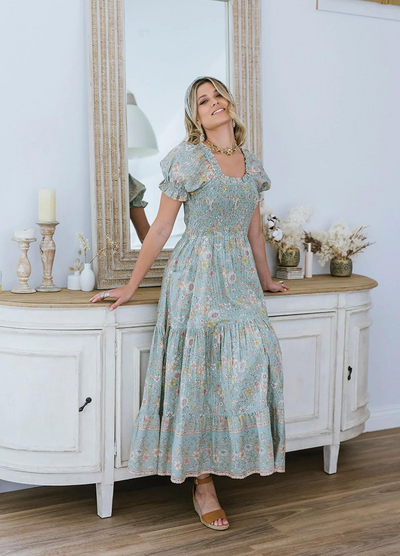 Model wearing the house of skye Daisy Belle dress in floral print with shirred bust and puff sleeve