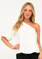 Model wearing white one shoulder top