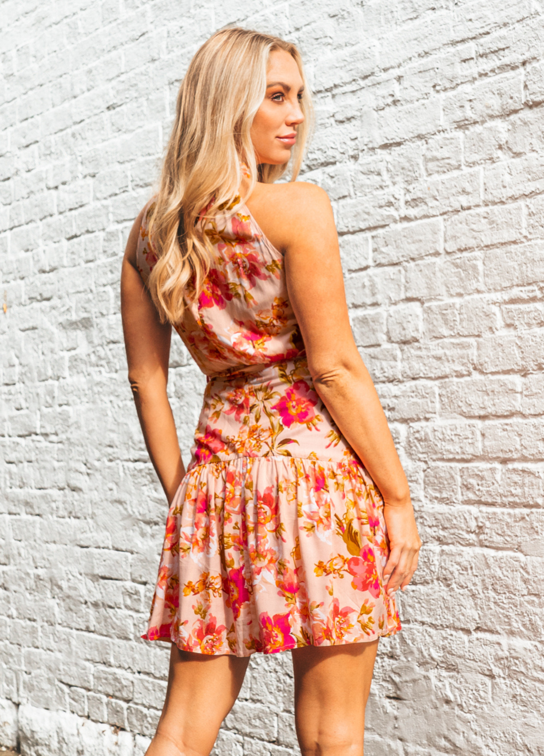 Model wearing the Calla Rose Mini Dress with tie waist belt and halterneck
