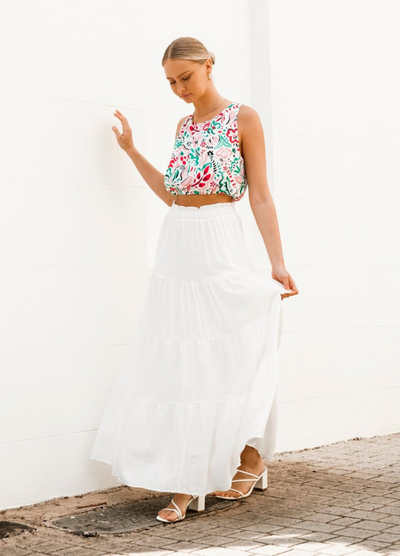 Model wearing a tiered off white maxi skirt with elasticated waistband